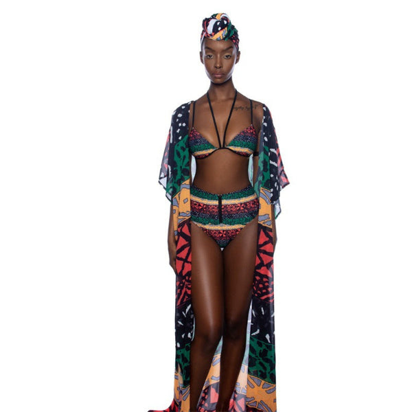 Woman wearing a colorful bikini and cover-up on a white background