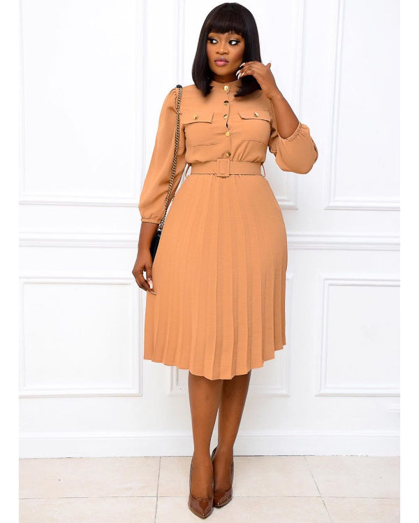 Woman wearing a tan dress with a white background