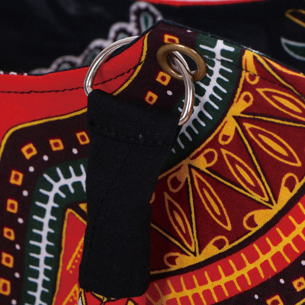 Close-up of a colorful fabric with a black strap and metal ring.