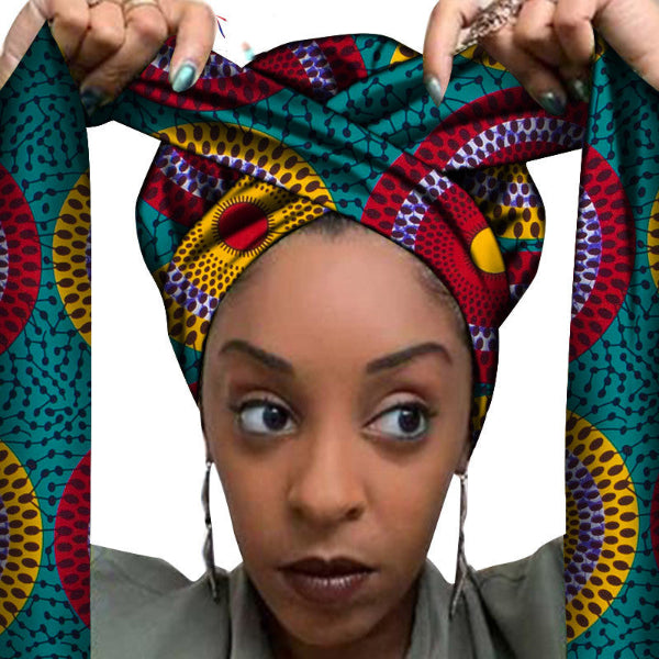 Woman wearing a colorful patterned headscarf with a white background