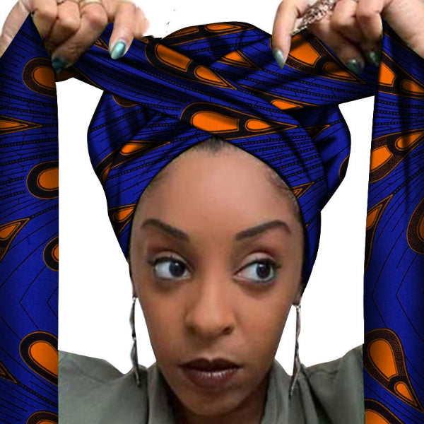 Woman wearing a blue and orange patterned headscarf with a white background