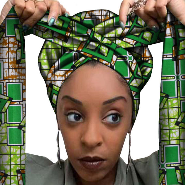 Person wearing a green and brown patterned headwrap with a decorative frame.