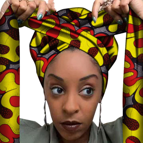 Woman wearing a colorful patterned headscarf with a white background