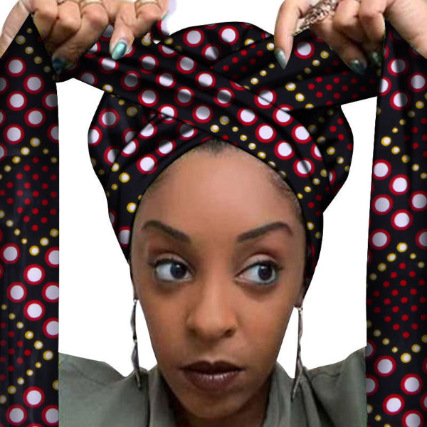 Woman wearing a polka dot headscarf with a white background