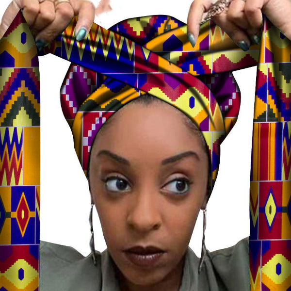 Woman wearing a colorful patterned headscarf with geometric designs.