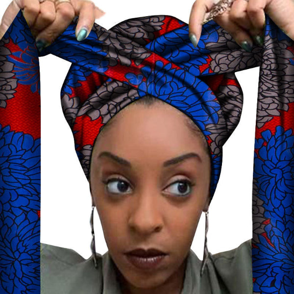 Woman wearing a colorful headwrap with blue, red, and black patterns.