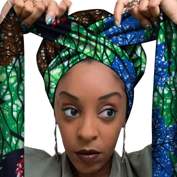 Woman wearing a colorful headscarf with green, blue, and brown patterns.