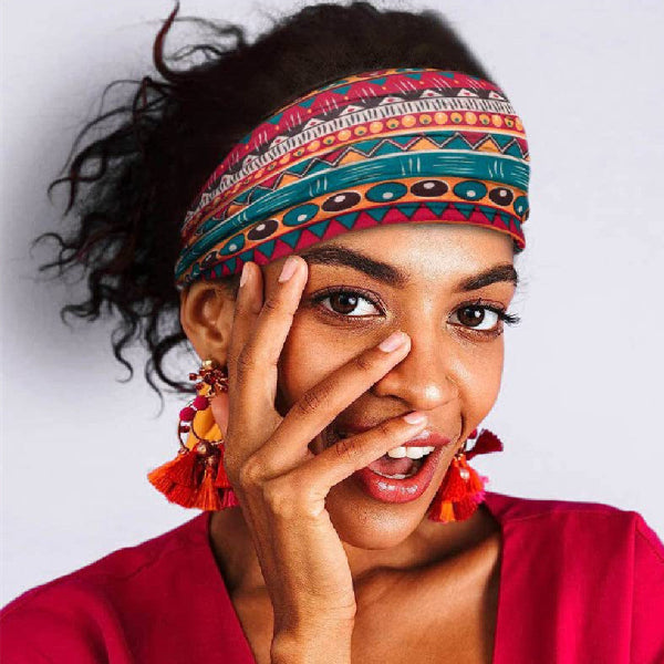 Woman wearing a colorful headband and earrings with a white background