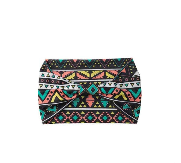 Multicolored geometric patterned headband on a white background