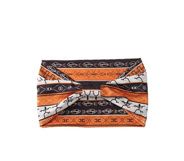 Patterned headband with orange, black, and white design on a white background